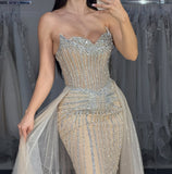 STRAPLESS CRYSTAL EMBELLISHED GOWN WITH OVERSKIRT